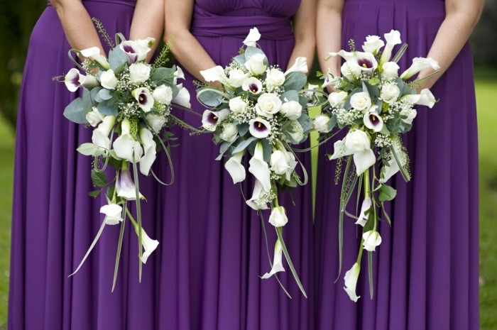three bridesmaids holding wedding bouquets