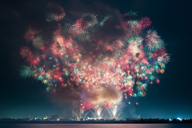 Feuerwerk fotografieren – So schnappen Sie die besten Silvesterfotos ganz viele feuerwerke bunt landschaft ferne